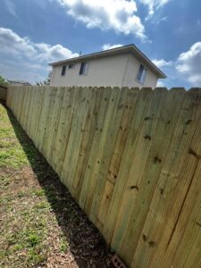 Newly completed wood privacy fence installation in a Hutto, TX residential backyard